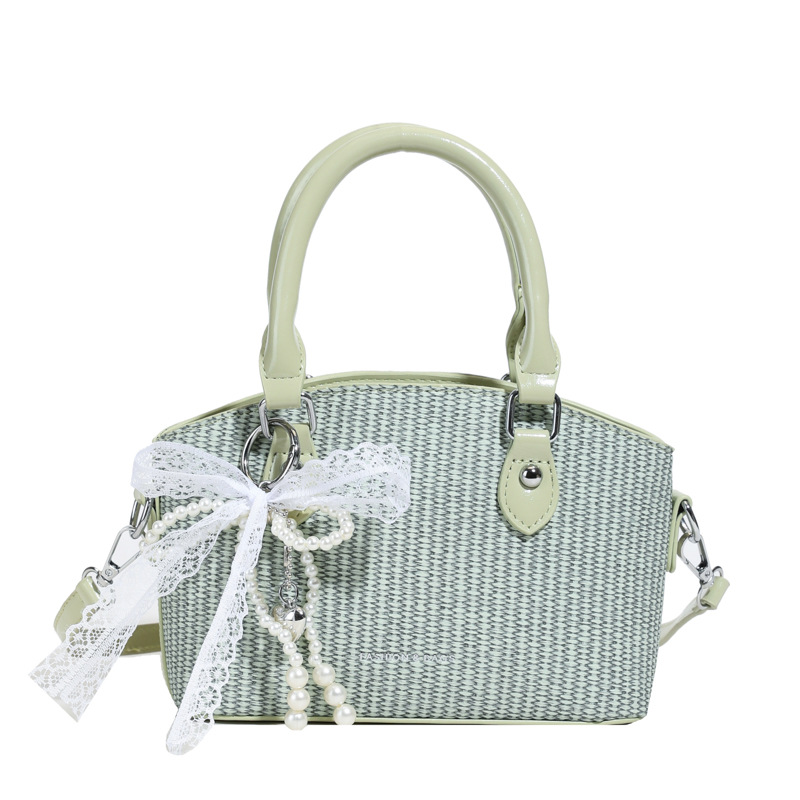 Vacaciones de verano en la playa de viajes bolsa de conchas de arena mujer 2025 este año bolsa de paja popular nueva bolsa de hombro tejida