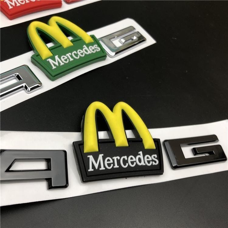Mercedes-Benz C-Class, E-Class, and S-Class modified with AMG emblems, McDonald's car logos, BMW M logos, and new AMG tail emblems with black lettering