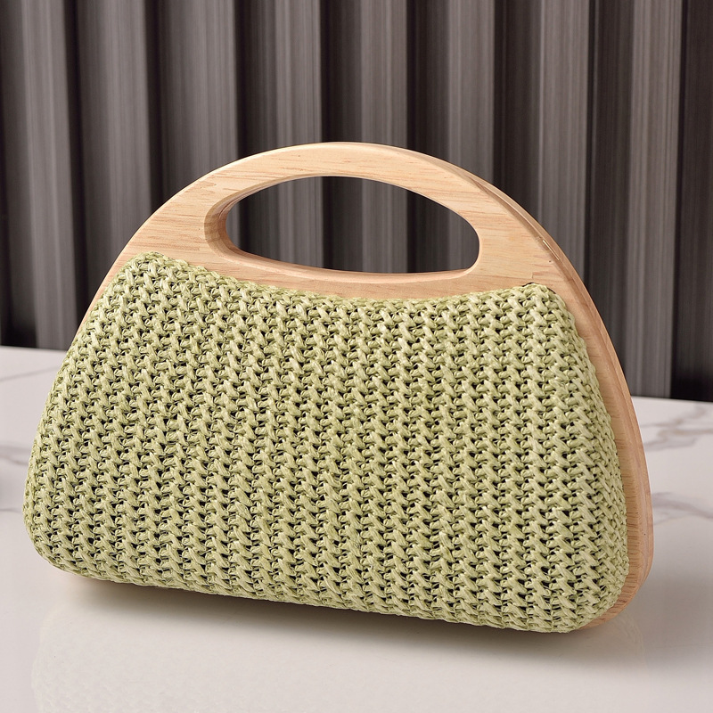2025 nuevo bolso de mujer con clip de madera maciza tejido de paja bolso de verano de vacaciones junto al mar pequeño bolso de mujer fresco venta caliente transfronteriza