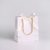 White bag, handheld hair band