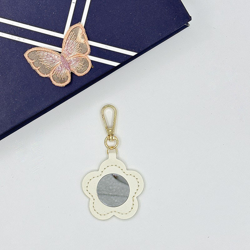 Flor espejo llavero cuero transfronterizo regalo colgante joyería creativo mini lápiz labial almacenamiento llavero colgante