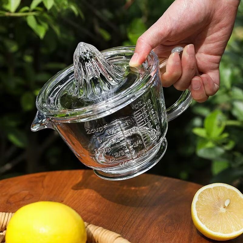 Thickened transparent glass cup with handle, suitable for whisking eggs, baking, cooking, and manual juicing; also functions as a measuring cup and a lemon cup for home use