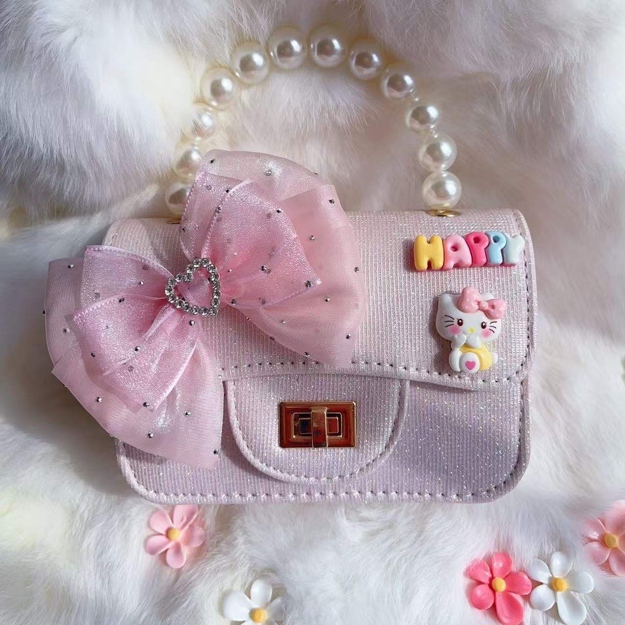 2025 nuevo arco bolsos para niños pequeños perlas de moda accesorios bolsos de cambio princesa bolsos de mano diagonales