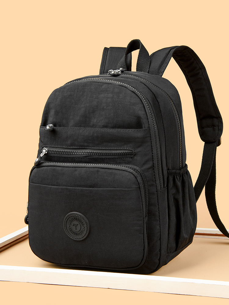 Mochila de hombro de comercio exterior 2025, nueva mochila de computadora simple de color sólido, mochila de escuela secundaria, mochila para hombres y mujeres.