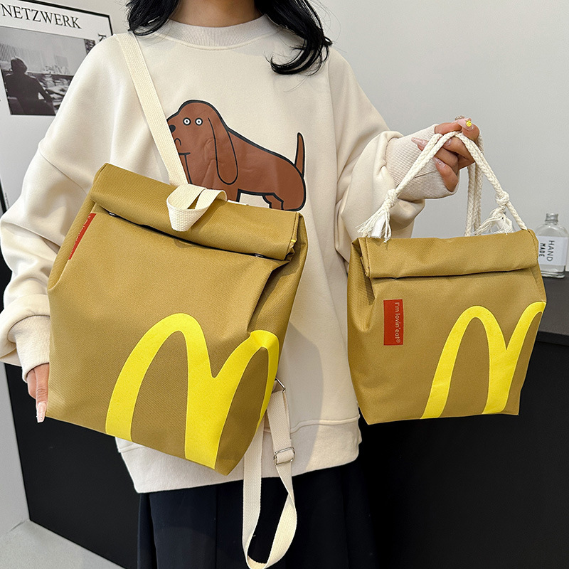 Mochila escolar al por mayor de McDonald's 2025 nueva mochila de papel con letras impresas personalizada para estudiantes universitarios exportación.