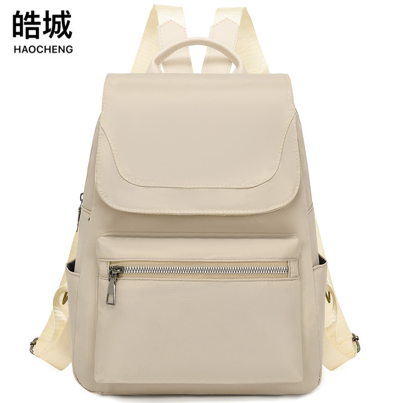 Mochila de color sólido para mujer 2025 moda coreana simple y salvaje mochila de tela Oxford mochila de viaje de ocio para mujer al por mayor