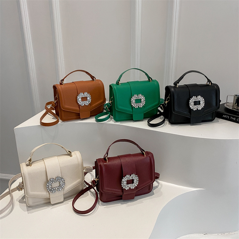 Bolso popular este año 2025, nuevo estilo simple de moda, mochila con patrón de litchi, bolso de viento simple, bolso de hombro casual.