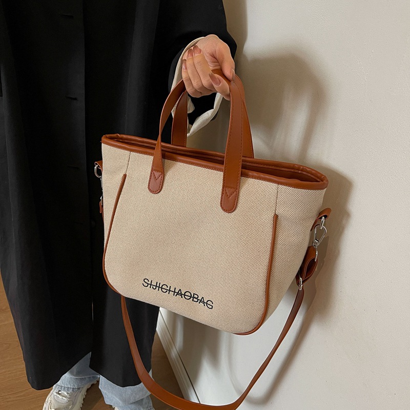 Estilo coreano de moda de contraste de color lienzo bolsa de mano portátil para las mujeres 2023 transfronteriza nueva textura de alto grado de hombro bolsa de mensajero