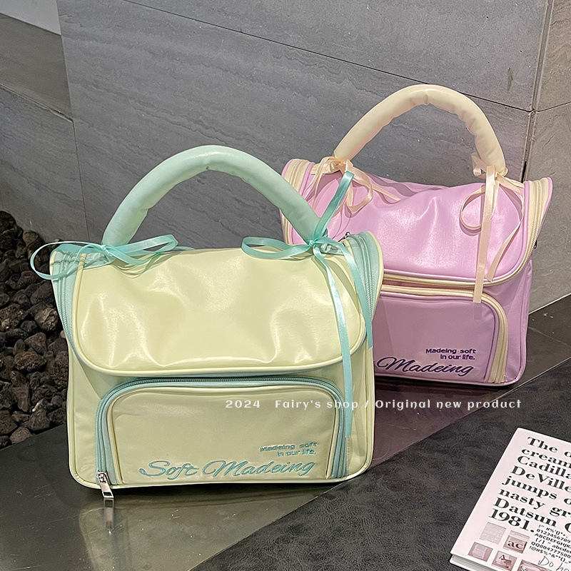 Handheld capacious cosmetic bag with bow to go out