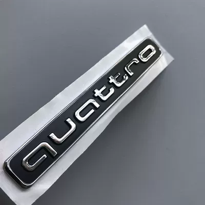 Car logo: lettering and four-ring emblem