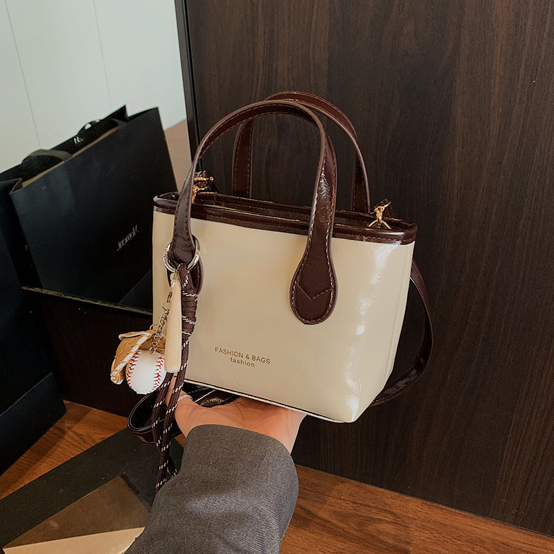 Bolso de cubo de textura de color sólido para mujer 2025 primavera nueva moda bolso de mensajero coreano estilo occidental de alta gama para mujer