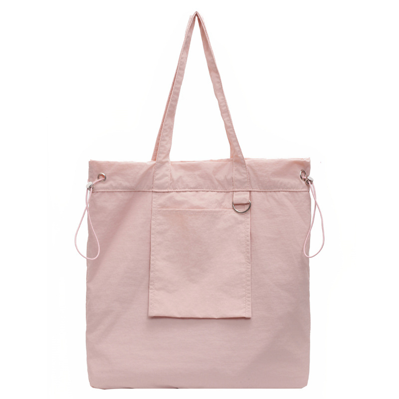 Bolsa de tela de nylon impermeable para mujeres 2025 nuevo tipo bolso de cubo de viaje ligero de gran capacidad bolso de hombro portátil para estudiantes universitarios