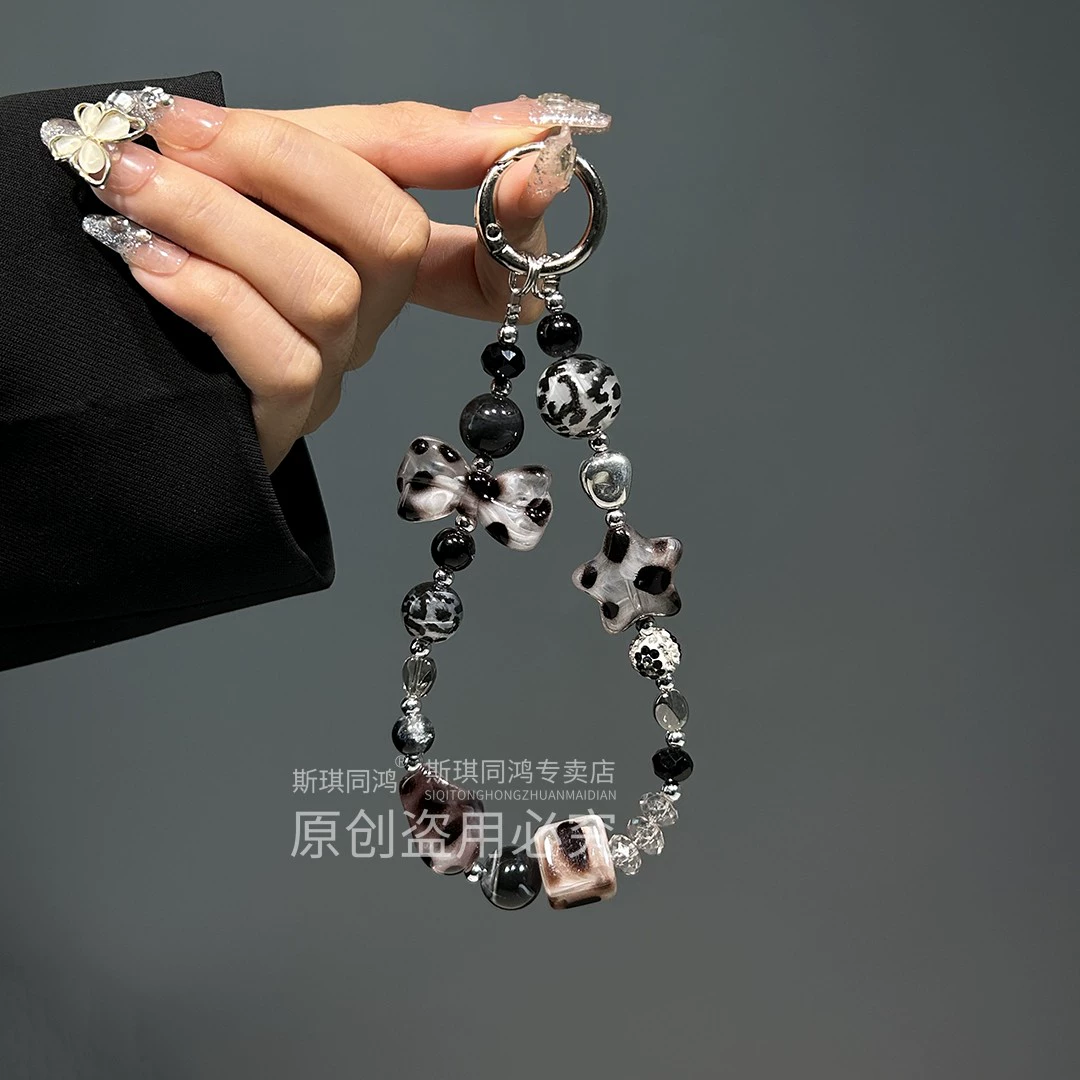 Mobile phone with bow, strap, sophisticated bracelet, pendant
