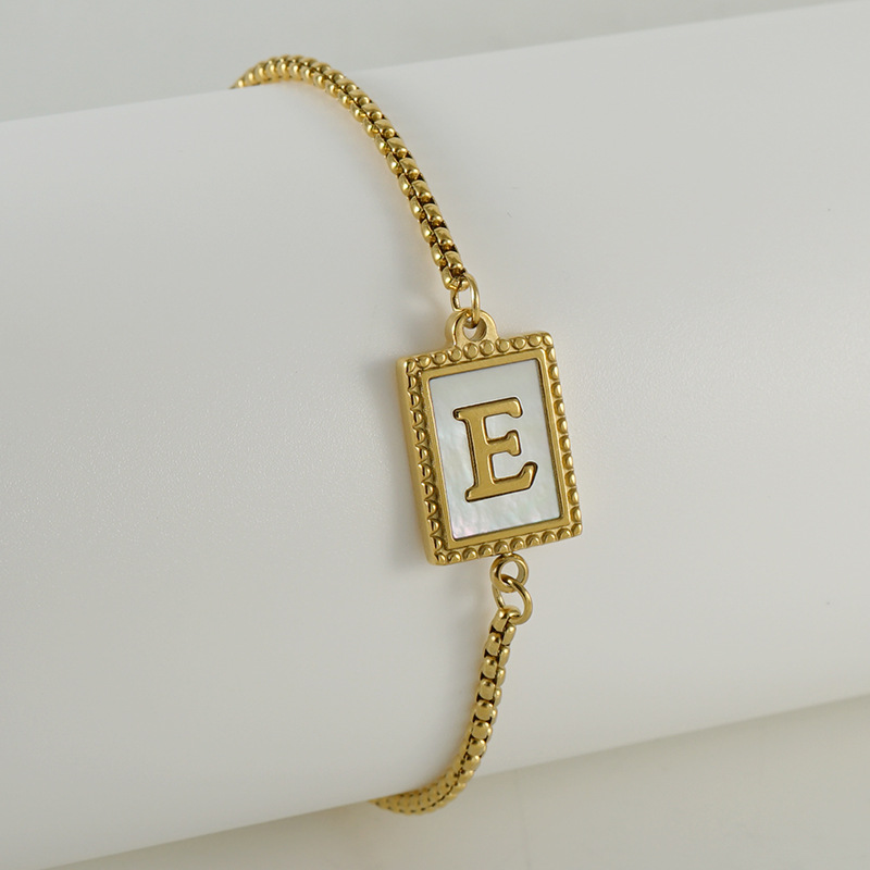 Nuevo europeo y americano transfronterizo de acero inoxidable 26 letras inglesas Shell pulsera personalidad todo partido titanio acero 18K cremallera