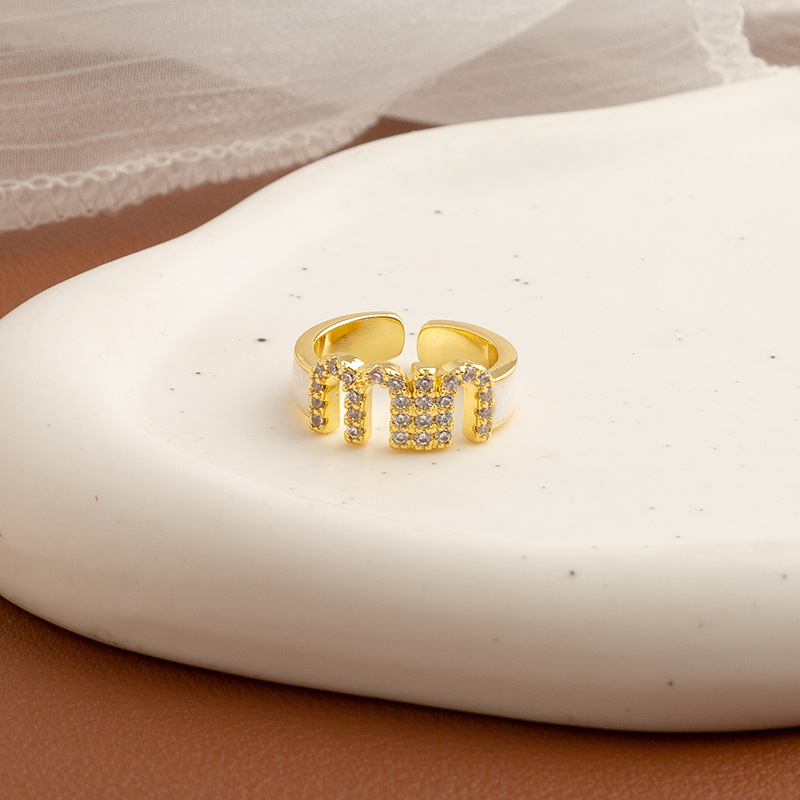 Golden ring with letters