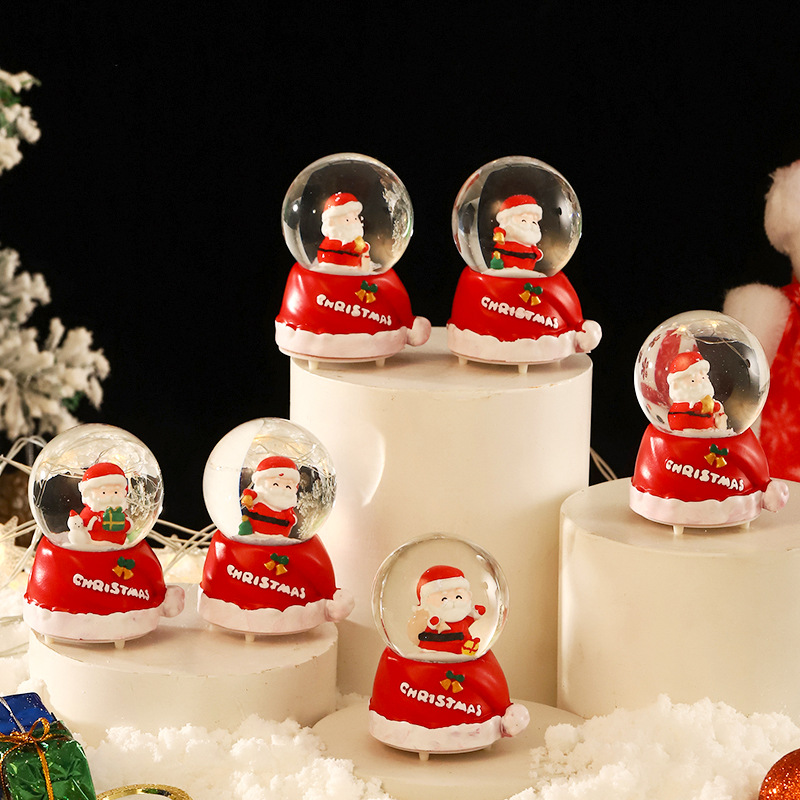 Una variedad de regalos de decoración de Navidad Navidad iluminante bola de cristal caja de música ventana diseño de velas lámparas de viento árbol de Navidad