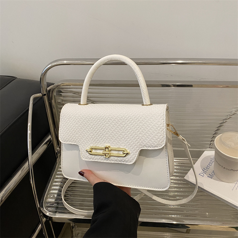 Bolso pequeño portátil casual retro femenino 2025 nuevo bolso cuadrado pequeño de moda coreana textura hebilla bolsa de mensajero de nicho