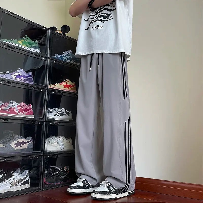 Pantalones casuales a rayas para hombres de primavera y otoño nuevos estudiantes adolescentes sueltos comercio exterior americano tres pantalones para hombres de verano