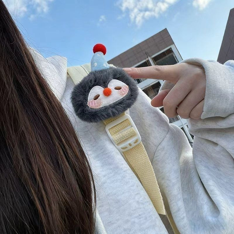 Lucky penguin and little fish plush toys attached to the shoulder straps of my backpack - a huggable Velcro strap for shoulder support.
