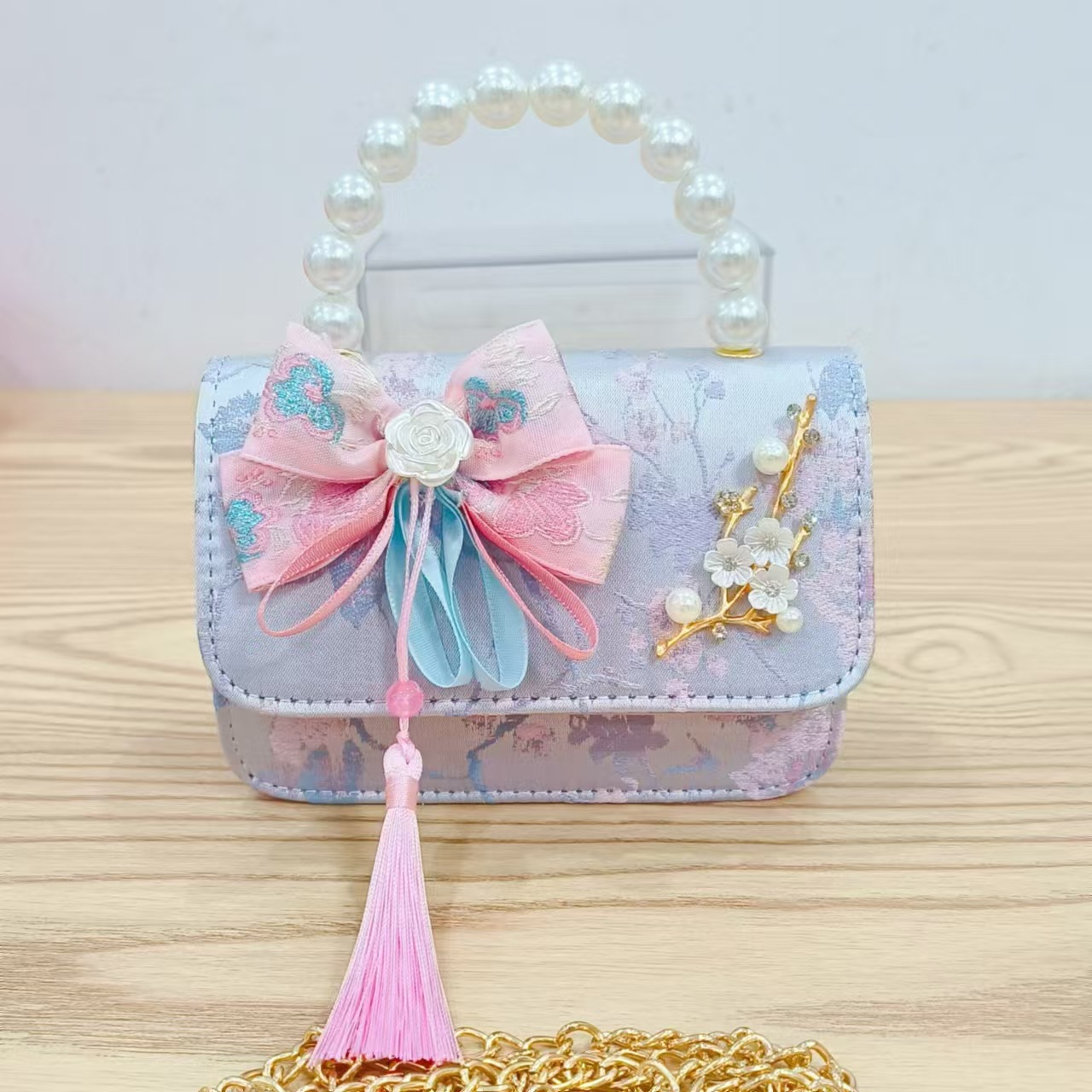 Bolsas de niños arco de estilo chino borda de niña pequeña princesa perla bolsa de cambio de mano al por mayor