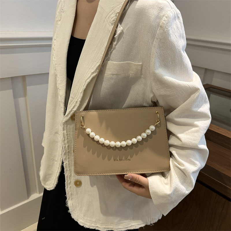 Bolso de nicho de sentido de alta gama para mujer 2024 nuevo bolso de hombro de cadena de perlas de moda salvaje bandolera bandolera