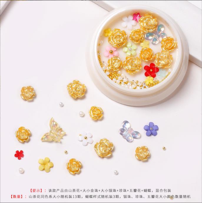 Nueva celebridad en línea suministros de uñas 3D multicolor de alto grado Camelia mariposa cinco pétalos flor bola de acero joyería de uñas diamante