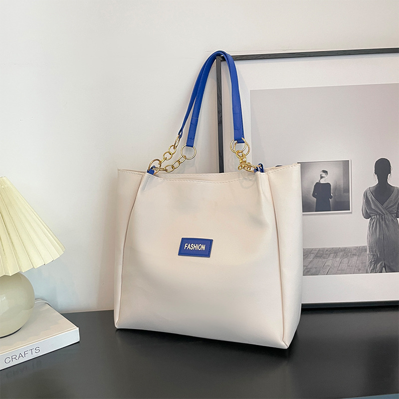 Este año, la textura Popular de gran capacidad tote paquete para mujeres 2024 nuevo paquete de clases para estudiantes de ocio de moda de moda paquete de cercanías