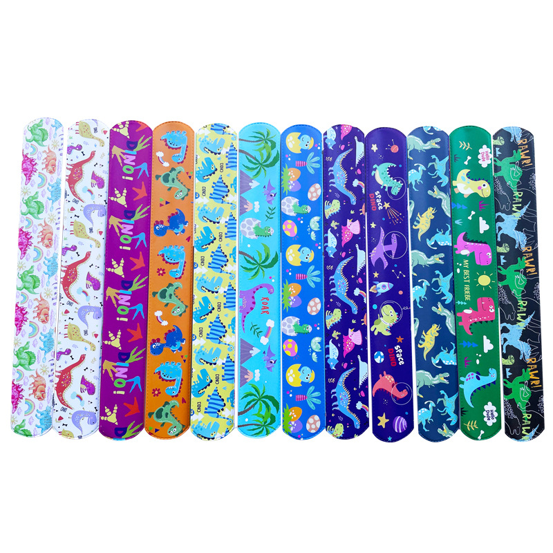 Nuevo mundo jurásico dinosaurio Snap anillo retro dinosaurio huevo huellas partido PVC raqueta anillo pulsera de los niños