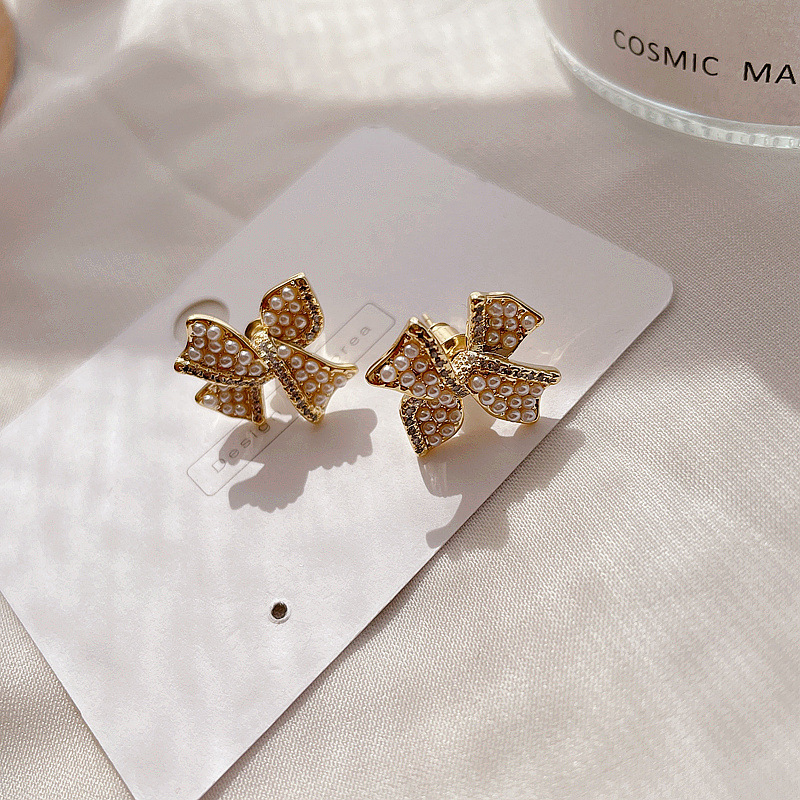 Micro-inlaid Pearl Golden Bow Fashion Earrings display picture 7