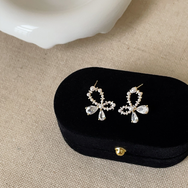 Small design fashionable elegant earrings with zircon pearl with bow