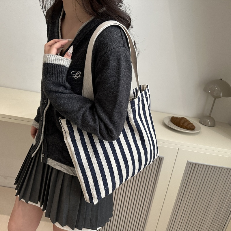 The new cross-border vertical striped commuter tote bag, hand-held shoulder bag, is fashionable and has a large capacity. It features an InS-style simple letter sail undefined