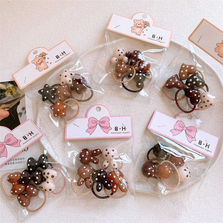 Caramel-colored children's polka-dot bow hair ties, cute cartoon designs that gently hold hair—perfect for girls' ponytail holders and elastic hairbands.