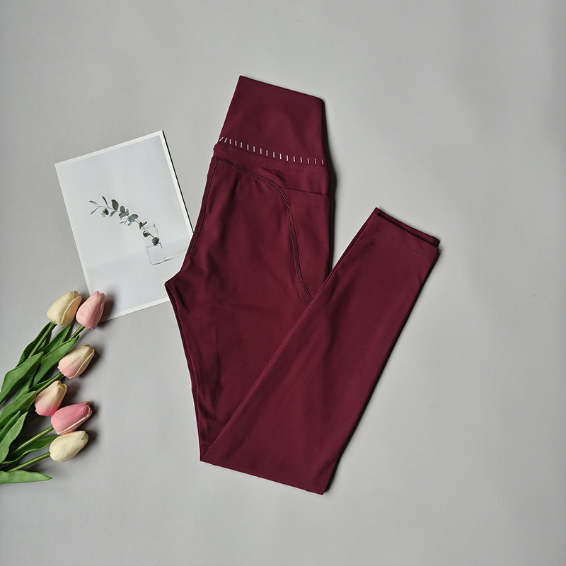 Pantalones de fitness desnudos para mujeres sonrientes líneas de elevación de cadera pantalones deportivos para mujeres al aire libre cintura alta sin marcas nueve puntos pantalones de calzado