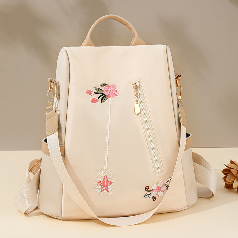 Mochila antirrobo de gran capacidad para mujer con bordado de flores de nuevo estilo Mochila de viaje de ocio de nailon antiagua de moda al por mayor