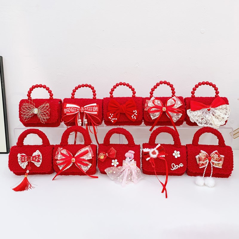 Bolsa de hombro de niña roja de Año Nuevo lindo arco borracha bolsa de bebé 2025 nueva cadena bolsa de niños