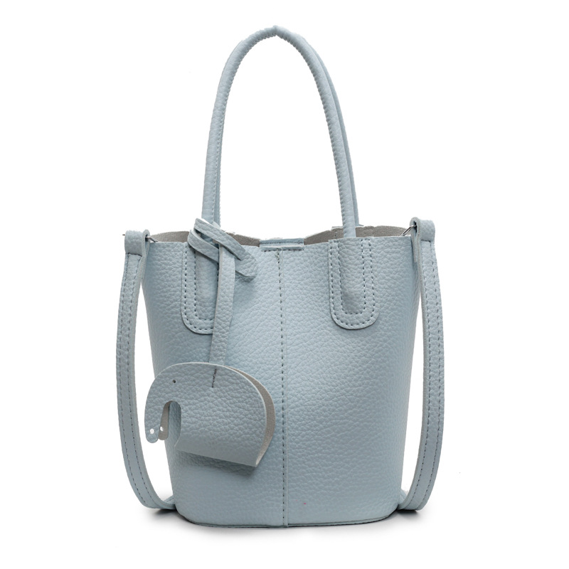 Bolso de cubo de venta caliente de comercio exterior, sentido de alta gama de nicho femenino 2025 nuevo bolso de mano simple y versátil, bolso de mensajero de moda y versátil