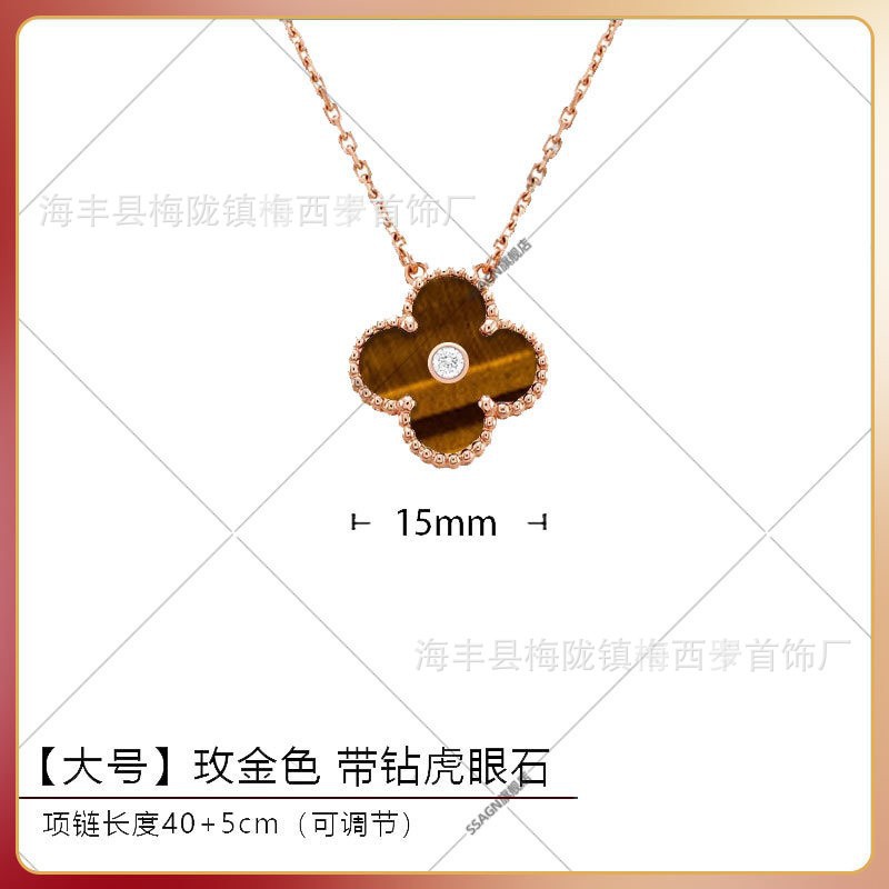 Large four-leaf clover necklace in rose gold with tiger eye stone and diamonds in the middle