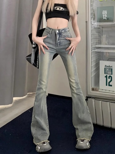 Slightly flared denim jeans for women: vintage autumn style, high waist, slimming fit, with a niche design and raw-edge hem.