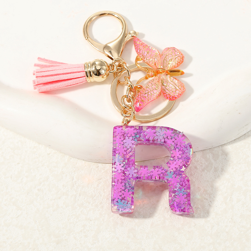 Nuevo color púrpura claro mezcla de polvo brillante letras inglesas resina llave colgante estilo simple mariposa borda colgante