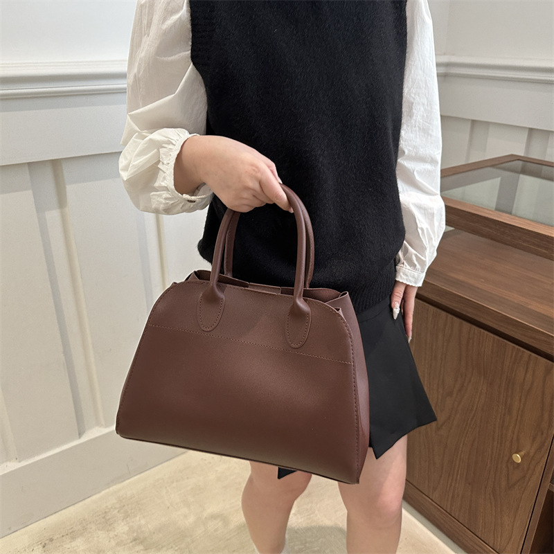 Europa y los Estados Unidos de moda retro sensación extranjera de gran capacidad bolso de cubo portátil de mujer 2025 primavera nueva moda simple bolso de tote