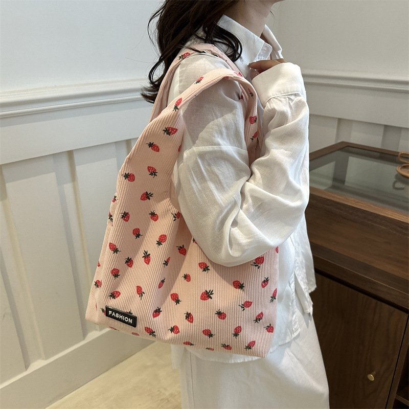 Bolso de meandruño 2024 nuevo hombro de gran capacidad bolso de mano de transporte literario versátil impresión brazaleta