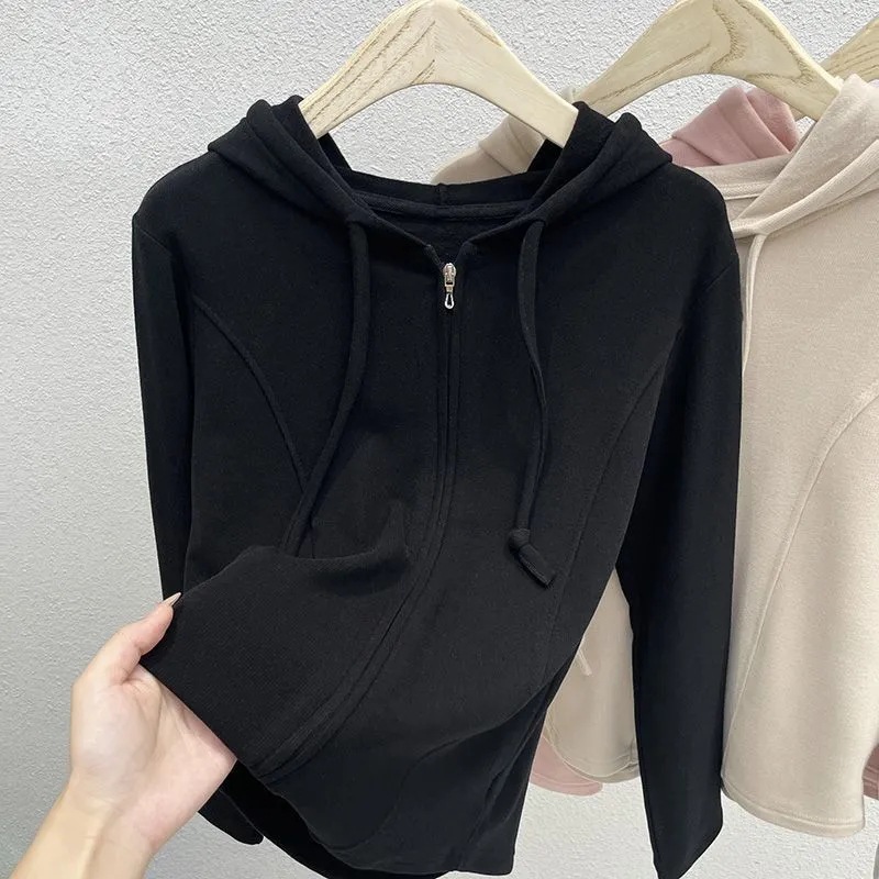 Plus-size women's hooded sweatshirt with a solid color design, unique fishbone pattern, structured shoulders, slimming effect, and a zip-up front