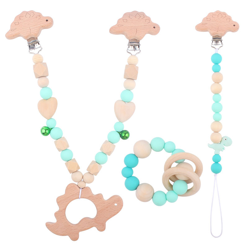 Suministros para bebés pulsera de silicona molar de juguete para niños Cadena de cochecito de dinosaurio de tres piezas creativa pequeña campana colgante
