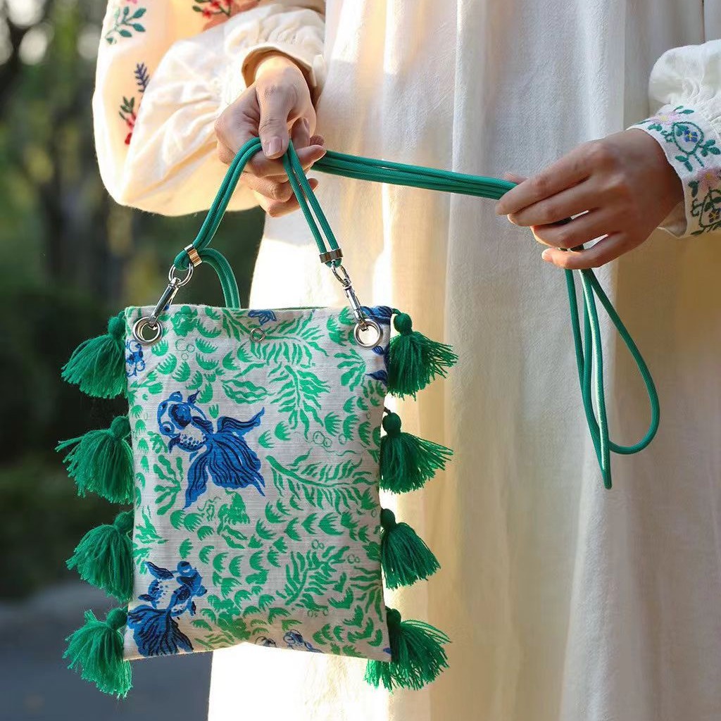 2025小衆のオリジナルデザインは色のフリンジキャンバスの携帯電話にぶつかって国の潮の新しい中国式の古い粗布を包んで肩掛けします。