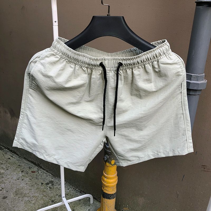 Pantalones de cuatro puntos Pantalones cortos casuales de verano para hombres Pantalones de playa de color caramelo para hombres de moda Pantalones de tres puntos deportivos sueltos de secado rápido