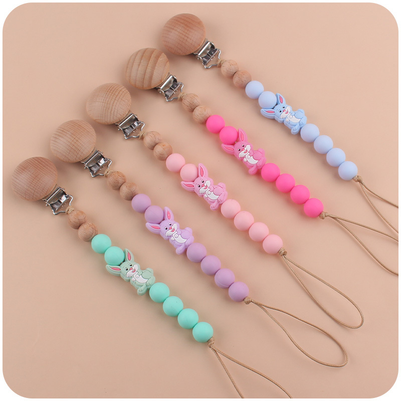 Nuevo bebé suministros dibujos animados conejo mordedor creativo lindo DIY mordedura molar pezón cadena anti-gota cuerda de la cadena