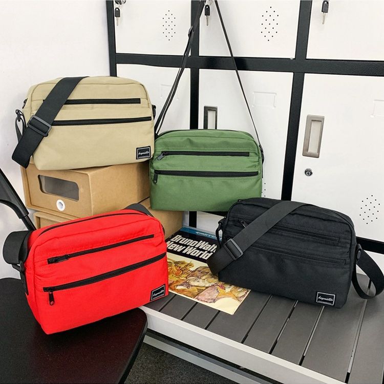 Bolso de hombro de los hombres japoneses ins estilo bolso de mensajero casual personalizado de moda estilo coreano bolso de mensajero estudiante pequeño bolso de hombro femenino