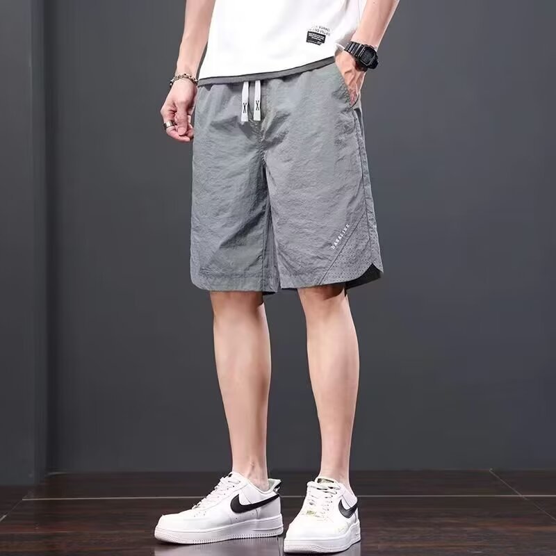 Camisas, menos ropa, pantalones de verano de cinco puntos, holgados y cómodos, todo-fósforo, pantalones casuales de estilo de Hong Kong, deportes para hombres, hombres estadounidenses, de secado rápido