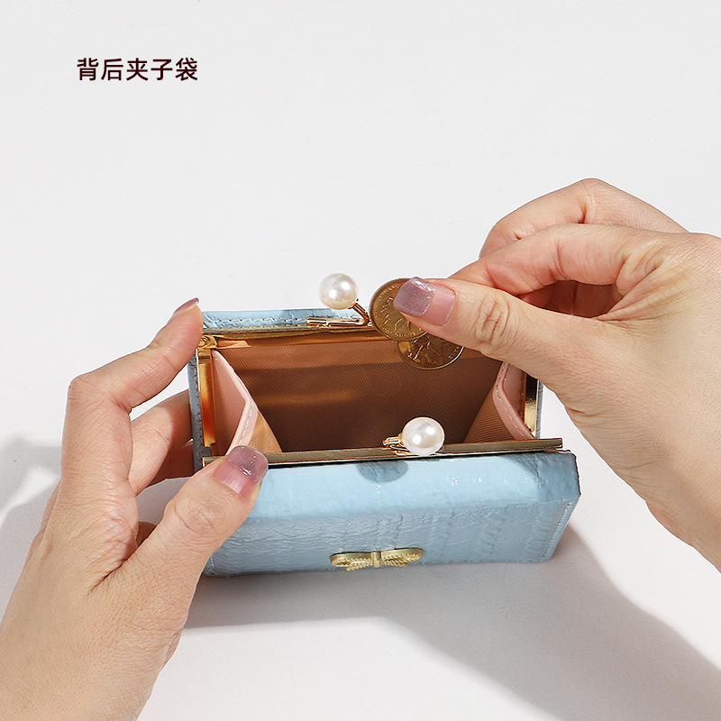 2024 nueva versión coreana de la billetera pequeña femenina corta de tres pliegues, billetera plegable para estudiantes, billetera de tarjeta de mariposa linda de dibujos animados, billetera