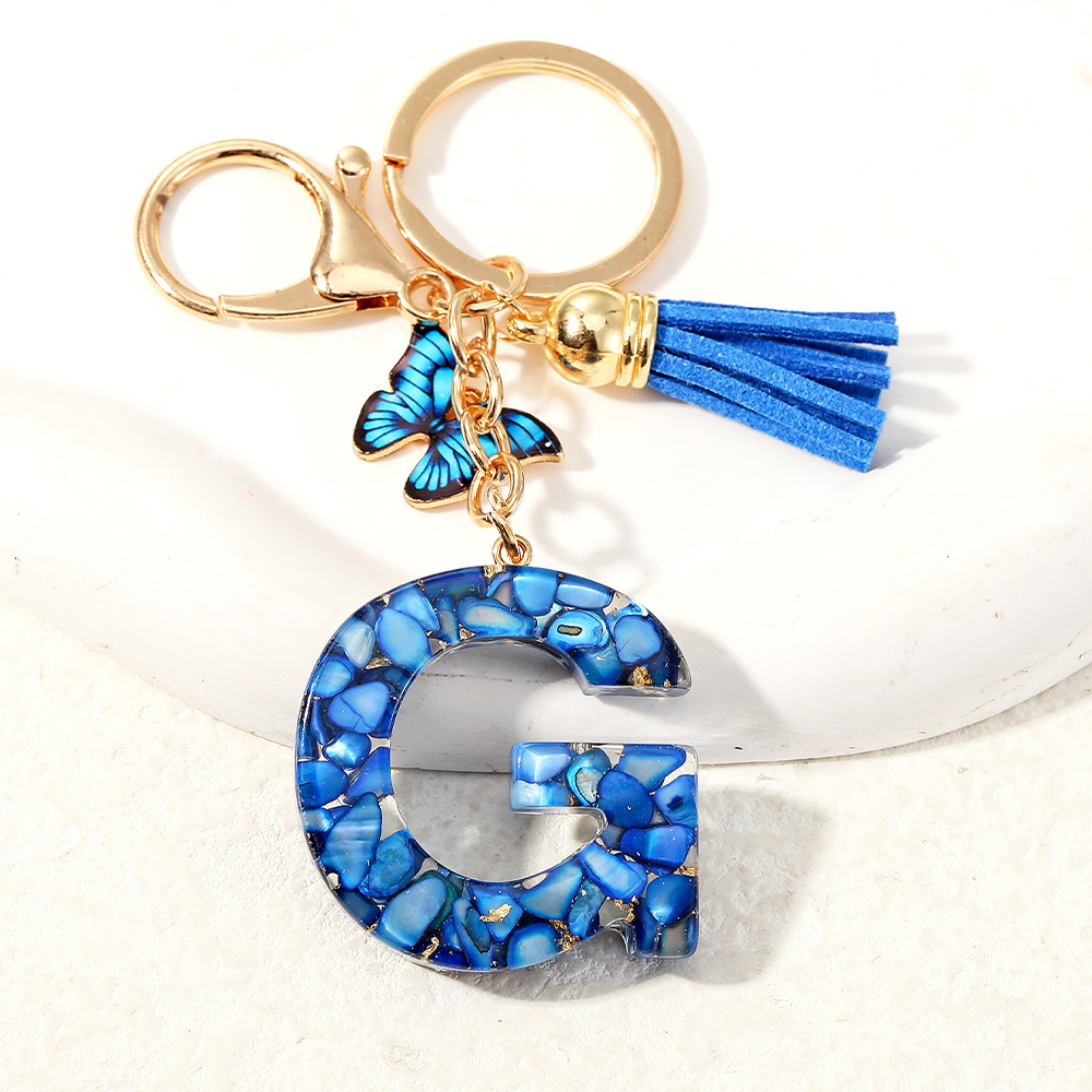 Nuevo transfronterizo mariposa 26 letras inglesas de cristal goteo llavero bolsos accesorios colgante de automóviles